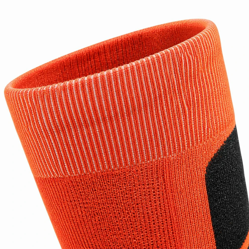 Close-up of the elastic cuff on orange and black thermal ski socks