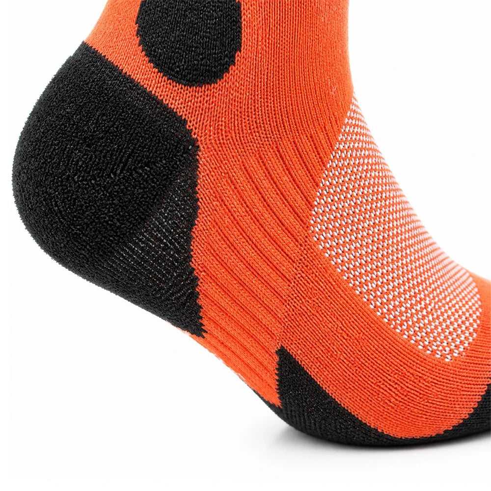 Close-up of cushioned heel construction on orange and black ski socks