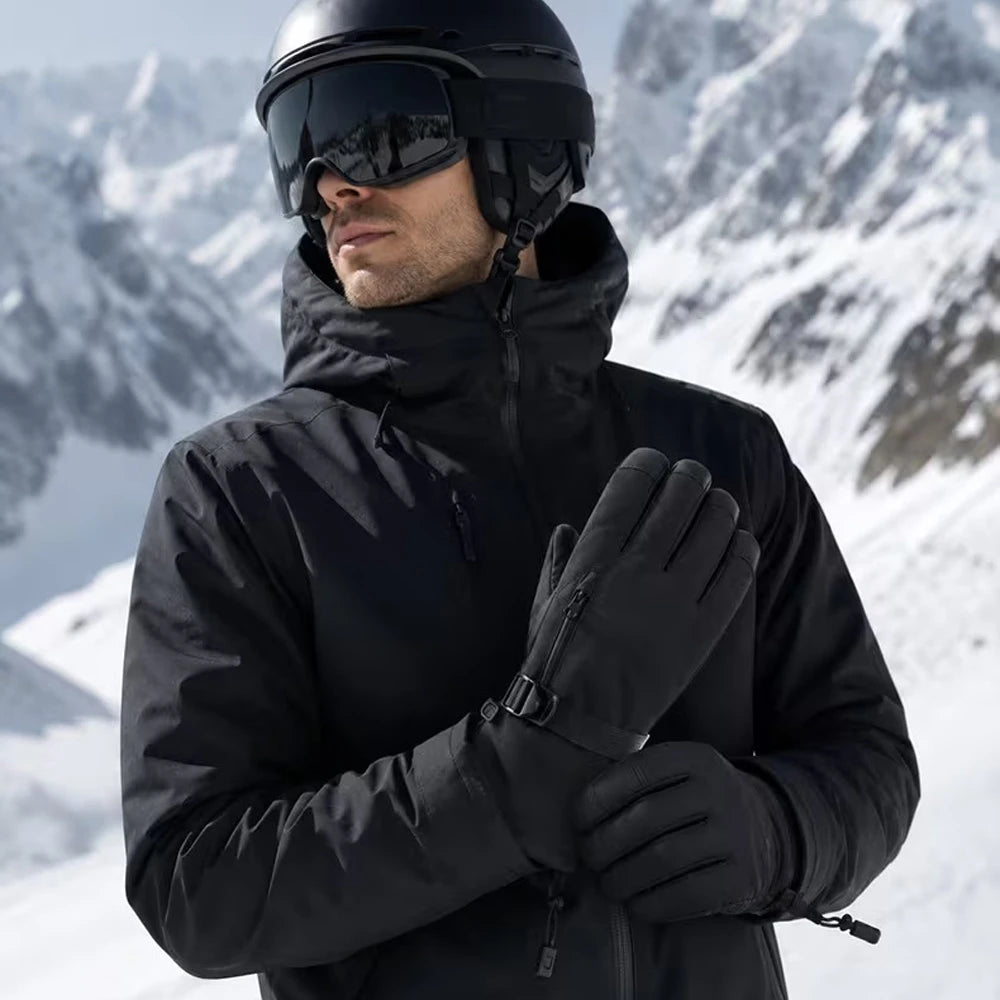 Skier wearing black insulated ski gloves in a snowy mountain setting