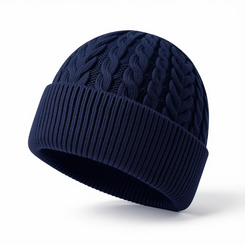 Navy blue cable knit beanie with ribbed cuff and classic textured pattern.