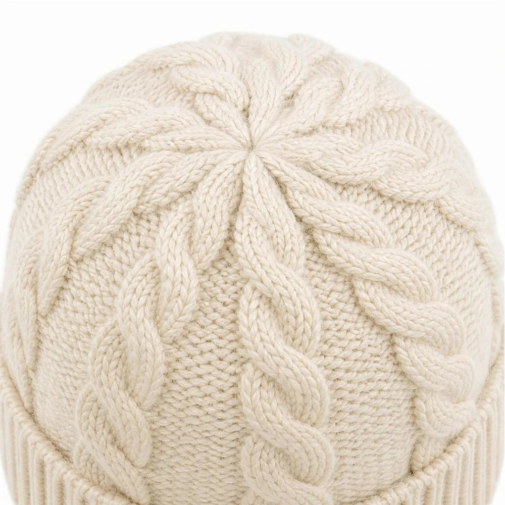 Close-up of the crown design on a white cable knit beanie showing neat finishing.