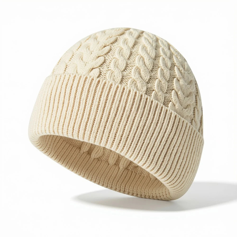 White cable knit beanie with ribbed cuff and classic textured pattern.