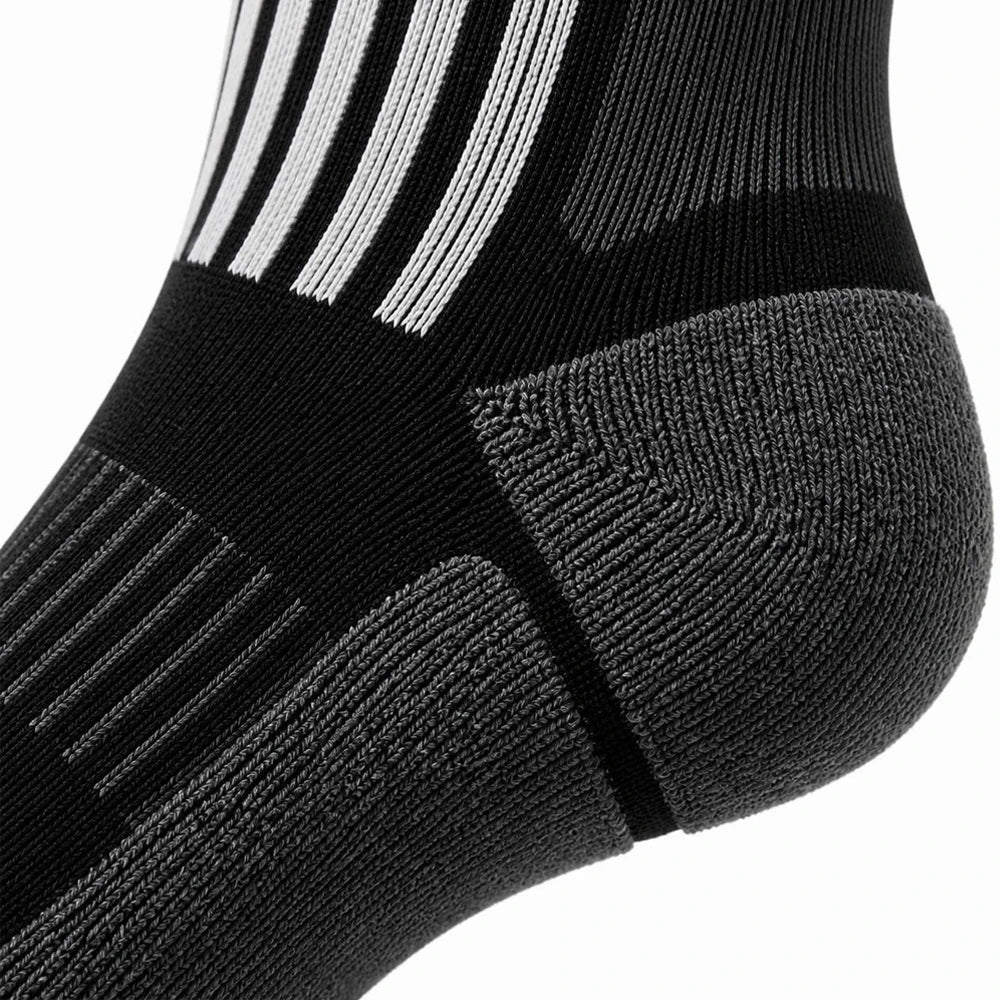 Close-up of the grey cushioned heel and arch support on black ski socks.