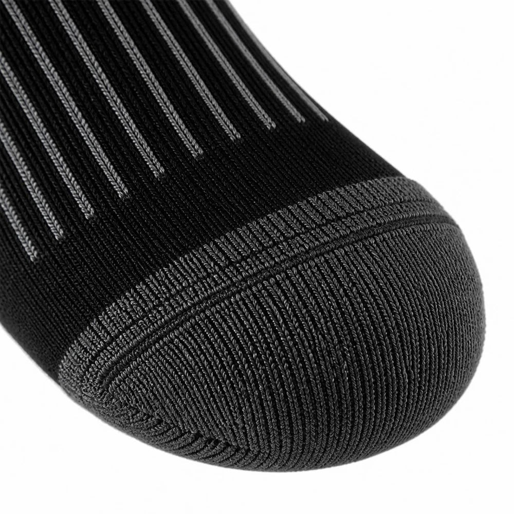 Close-up of the reinforced toe on black merino wool ski socks with seamless stitching.