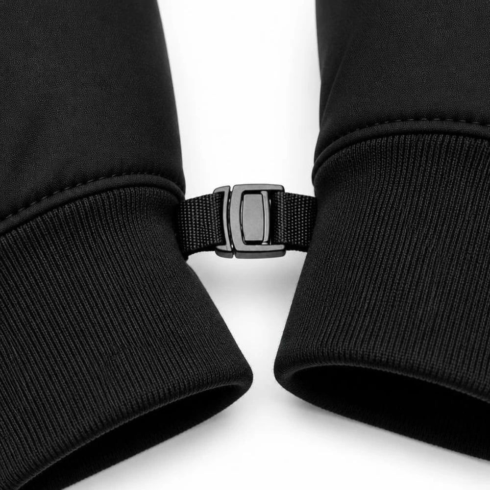 Close-up of the loss-prevention buckle and elastic ribbed cuff on black winter cycling gloves.
